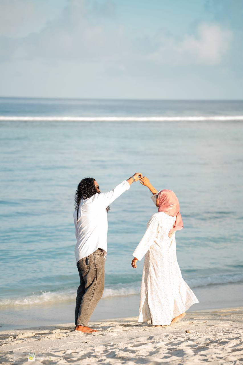 Wasiu and Shafga dancing barefoot on the beach