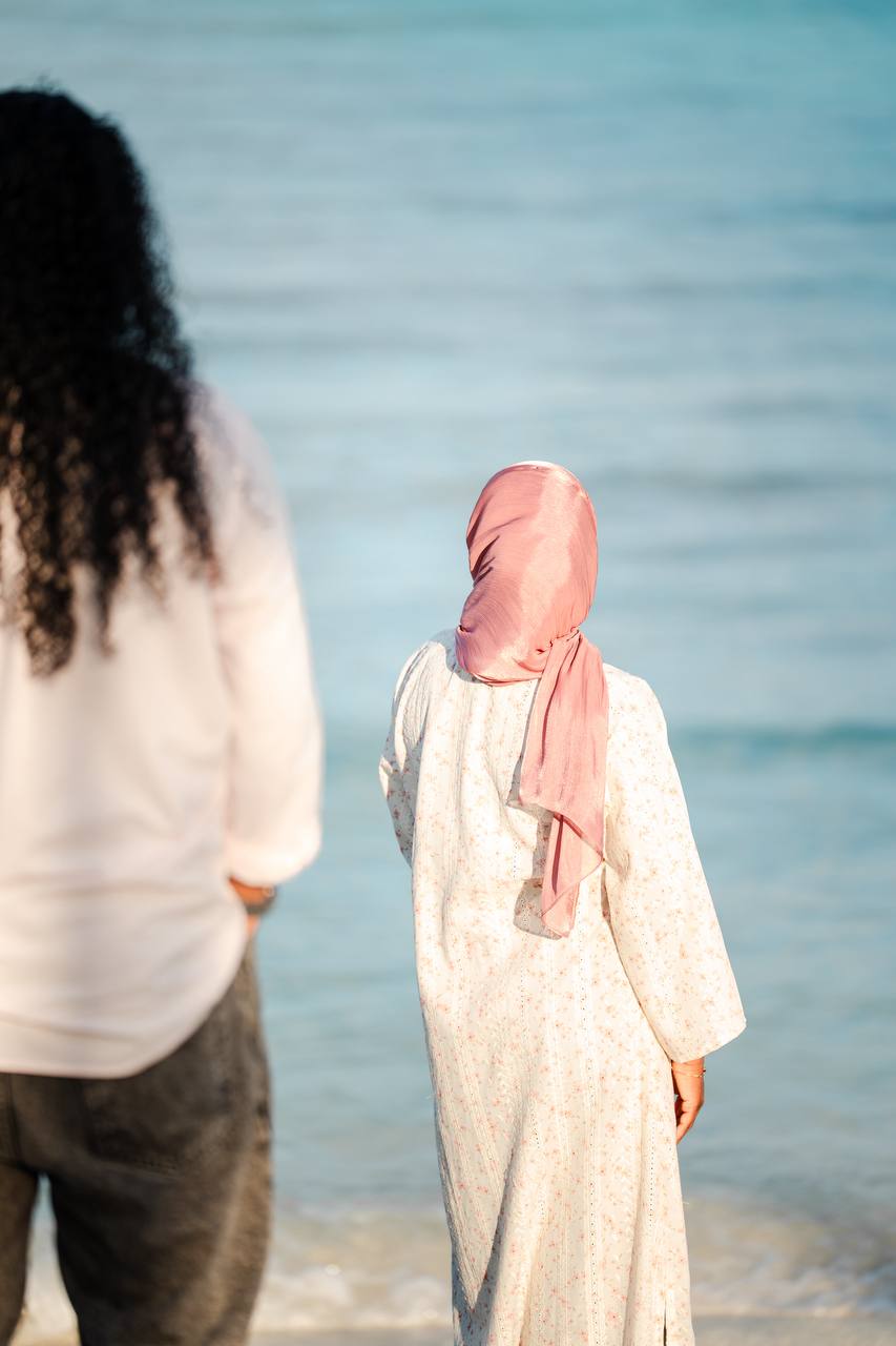 Shafga looking out at the sea, Wasiu beside her